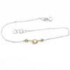 bracciale nodo con catenina in oro bianco e centrale in oro giallo a filo